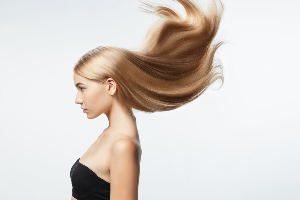 beautiful-model-with-long-smooth-flying-blonde-hair-isolated-on-white-studio-background-young-caucasian-model-with-well-kept-skin-and-hair-blowing-on-air